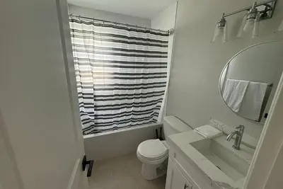 a bathroom with a toilet and a sink and a mirror at Amazing La Jolla Ocean View 2 bedroom apartment in San Diego