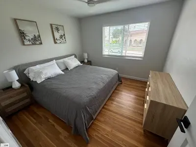 a bedroom with a bed and a wooden table at Amazing La Jolla Ocean View 2 bedroom apartment in San Diego