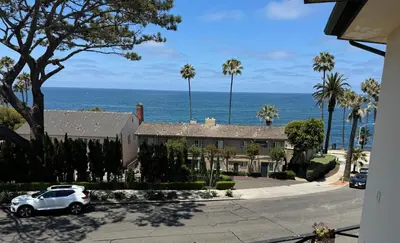 a white car parked in front of a house at Amazing La Jolla Ocean View 2 bedroom apartment in San Diego