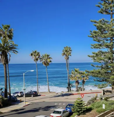 a view of a street with palm trees and the ocean at Amazing La Jolla Ocean View 2 bedroom apartment in San Diego