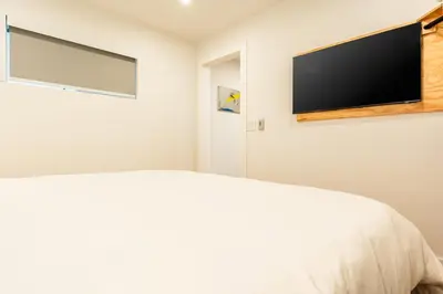 a bedroom with a bed and a flat screen tv at Simple La Jolla 2 bedroom - Alley Unit in San Diego