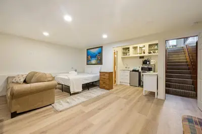 a living room with a bed and a couch at Private Spacious Full Bed Studio in San Diego