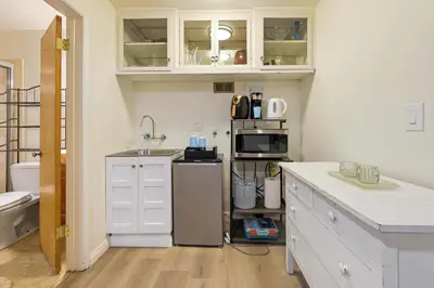 a kitchen with a sink and a microwave at Private Spacious Full Bed Studio in San Diego