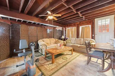 a living room with a couch and a table at Private Spacious Full Bed Studio in San Diego