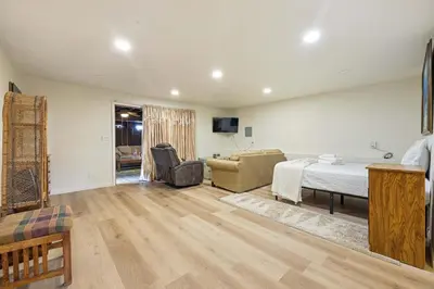 a bedroom with a bed and a living room at Private Spacious Full Bed Studio in San Diego