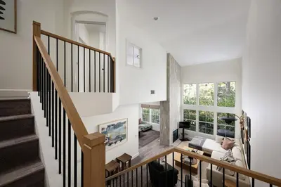a room with a staircase and a living room at Newport Coast Bungalow in Newport Beach