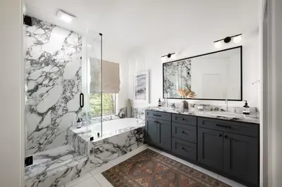 a bathroom with a tub and a sink and a mirror at Newport Coast Bungalow in Newport Beach