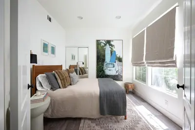 a bedroom with a bed and a bathroom with a sink at Newport Coast Bungalow in Newport Beach