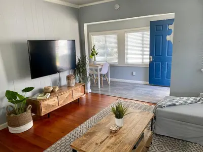 a living room with a flat screen tv and a couch at Charming 1 Bedroom Home with Hot Tub & Bonus Room! in San Diego