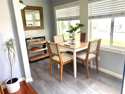 a dining room with a table and chairs and a mirror at Charming 1 Bedroom Home with Hot Tub & Bonus Room! in San Diego