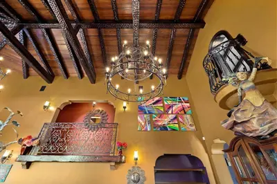 a chandelier hanging from the ceiling of a room at Skyline and Bay Views Spanish Villa Pool and Hot Tub in San Diego