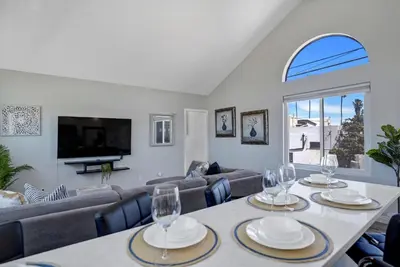 a living room with a table with wine glasses on it at Walk to Ocean Beach Stylish 2BR Apt with Patio in San Diego