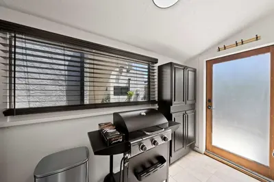 a kitchen with a stove and a window in it at Mid-City 2BR Retreat Firepit Nights with Free Parking in San Diego