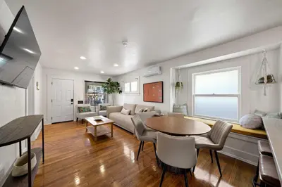 a living room with a couch and a table at Mid-City 2BR Retreat Firepit Nights with Free Parking in San Diego