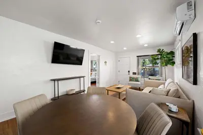 a living room with a table and a couch at Mid-City 2BR Retreat Firepit Nights with Free Parking in San Diego