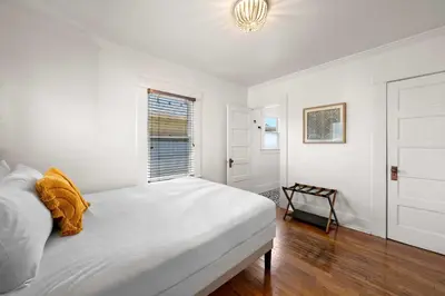a white bedroom with a bed and a window at Mid-City 2BR Retreat Firepit Nights with Free Parking in San Diego