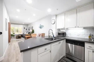 a kitchen with white cabinets and a sink at Casita Balboa Modern 1 BR close to Balboa Park in San Diego