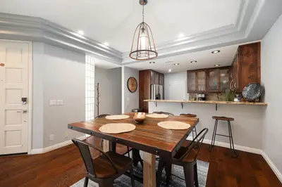 a kitchen and dining room with a wooden table and chairs at Surfing SapphirePrivate Rooftop Hot Tub wFirepit in San Diego