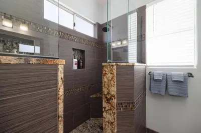a bathroom with a walk in shower with a glass door at Surfing SapphirePrivate Rooftop Hot Tub wFirepit in San Diego