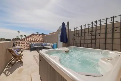 a hot tub on the balcony of a house at Surfing SapphirePrivate Rooftop Hot Tub wFirepit in San Diego