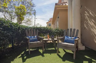 two chairs sitting next to a table in a yard at Surfing SapphirePrivate Rooftop Hot Tub wFirepit in San Diego