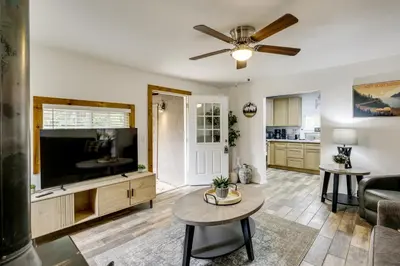 a living room with a flat screen tv and a table at Modern Backcountry Retreat! Bike and Hike Mt Laguna in Mount Laguna