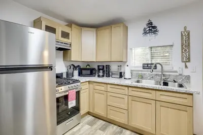 a kitchen with wooden cabinets and a stainless steel refrigerator at Modern Backcountry Retreat! Bike and Hike Mt Laguna in Mount Laguna