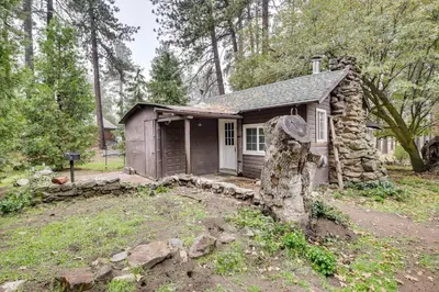 a small house in the woods with a large rock at Modern Backcountry Retreat! Bike and Hike Mt Laguna in Mount Laguna