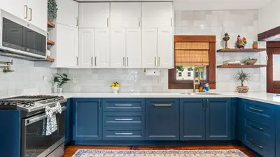 a blue and white kitchen with white cabinets at 2 Side-by-Side San Diego Homes w Shared Backyard Firepit BBQ Casa Craftsman Casita on Landis by Avantstay in San Diego