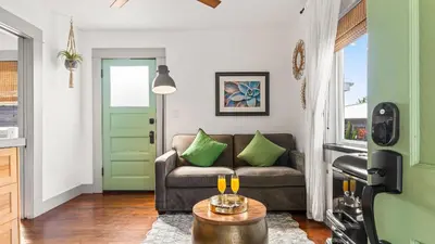 a living room with a couch and a table at 2 Side-by-Side San Diego Homes w Shared Backyard Firepit BBQ Casa Craftsman Casita on Landis by Avantstay in San Diego