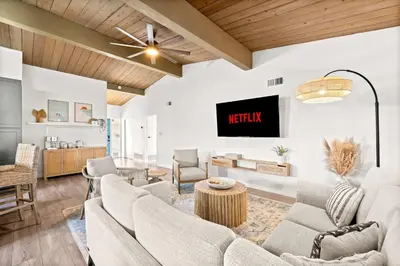 a living room with a couch and a tv at Spacious 4BR Retreat with Hot Tub Fire Pit and Patio in San Diego