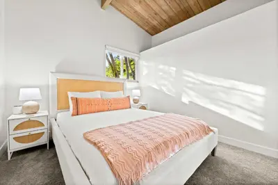 a white bedroom with a bed and a window at Spacious 4BR Retreat with Hot Tub Fire Pit and Patio in San Diego