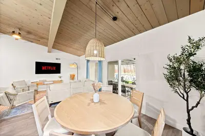 a dining room with a wooden table and chairs at Spacious 4BR Retreat with Hot Tub Fire Pit and Patio in San Diego