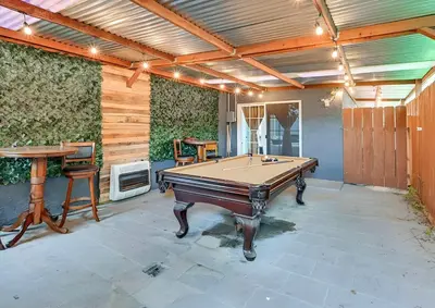 a patio with a pool table and a table at Spacious Family Getaway with Grill Firepit and Patio in San Diego