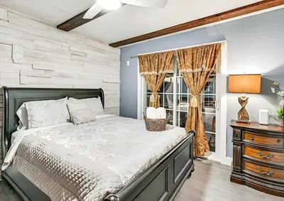 a bedroom with a bed and a window at Spacious Family Getaway with Grill Firepit and Patio in San Diego