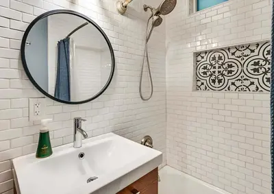 a white bathroom with a sink and a mirror at Spacious Family Getaway with Grill Firepit and Patio in San Diego