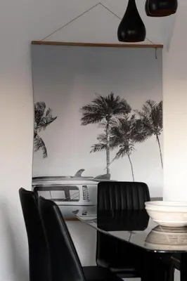 a dining room table with chairs and a picture of palm trees at Walk to beach Prime location Villa in San Diego