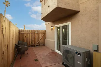 a patio with a tv and a fence at Walk to beach Prime location Villa in San Diego