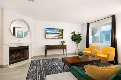 a living room with a couch and a fireplace at Walk to Beach Walk to hot spots Villa in San Diego
