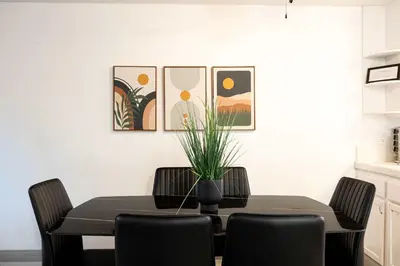 a dining room with a black table and chairs at Walk to Beach Walk to hot spots Villa in San Diego