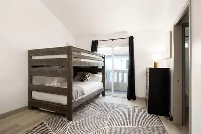 a bedroom with a bunk bed and a rug at Walk to Beach Walk to hot spots Villa in San Diego