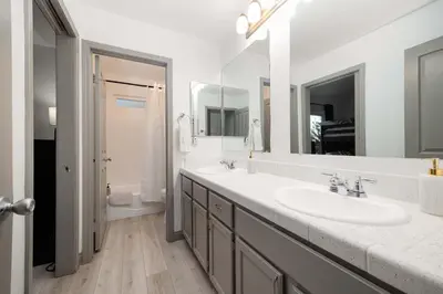 a bathroom with a sink and a large mirror at Walk to Beach Walk to hot spots Villa in San Diego