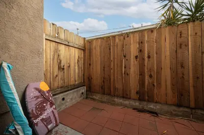 a wooden fence in a backyard with a tiled floor at Walk to Beach Walk to hot spots Villa in San Diego
