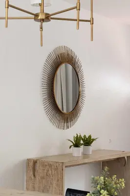 a mirror on a wall above a wooden table at Steps to beach Best Location Villa in San Diego