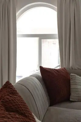 a couch sitting in front of a window at Steps to beach Best Location Villa in San Diego