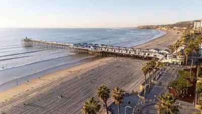 an aerial view of a beach with a pier at Steps to beach Best Location Villa in San Diego