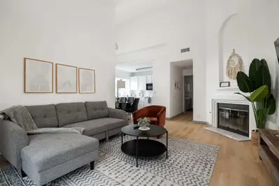 a living room with a couch and a table at Steps tp beach Prime location Villa in San Diego