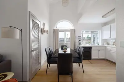 a kitchen and dining room with a table and chairs at Steps tp beach Prime location Villa in San Diego