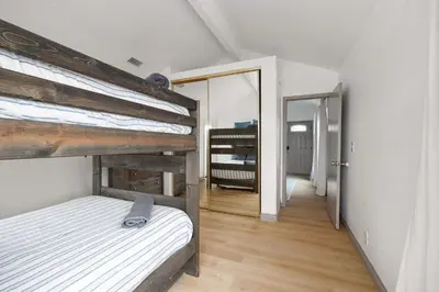 a bedroom with a bunk bed and a mirror at Steps tp beach Prime location Villa in San Diego