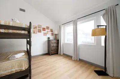 a bedroom with two bunk beds and a window at Steps tp beach Prime location Villa in San Diego